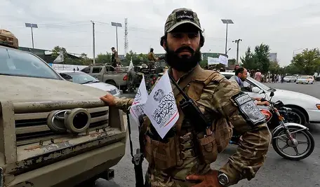 1280px-Taliban_member_with_chest_flags.webp
