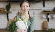 positive-young-woman-holding-bag-with-organic-vegetables (1)