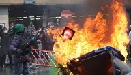 Protesters throw items into a fire during a demonstration organized by national trade unions against the federal government's planned economic and wage reforms in Brussels, Belgium, 09 October 2026. Students have joined workers in the protest after a week of demonstrations against education reforms across Belgium, some of which have led to violent clashes with police