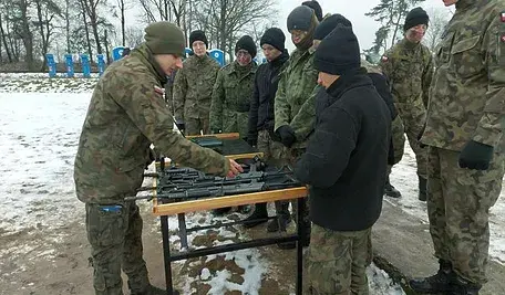 Polscy żołnierze oglądający broń.