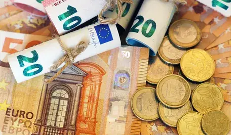 high-angle-view-some-rolled-banknotes-coins-more-banknotes