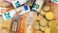 high-angle-view-some-rolled-banknotes-coins-more-banknotes