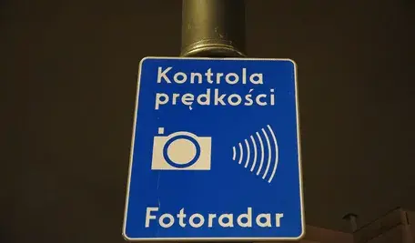 Fotoradar przy drodze monitorujący prędkość pojazdów. Zdjęcie ilustruje materiał dotyczący niskiej skuteczności egzekwowania mandatów za przekroczenie prędkości oraz planowanych zmian w przepisach.