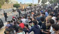 Migranci siedzący na ulicy w Ceucie